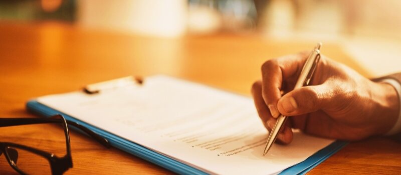 Lawyer hand showing paperwork for signing, agreement contract and settlement offer in law firm office