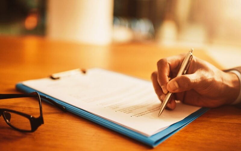 Lawyer hand showing paperwork for signing, agreement contract and settlement offer in law firm office
