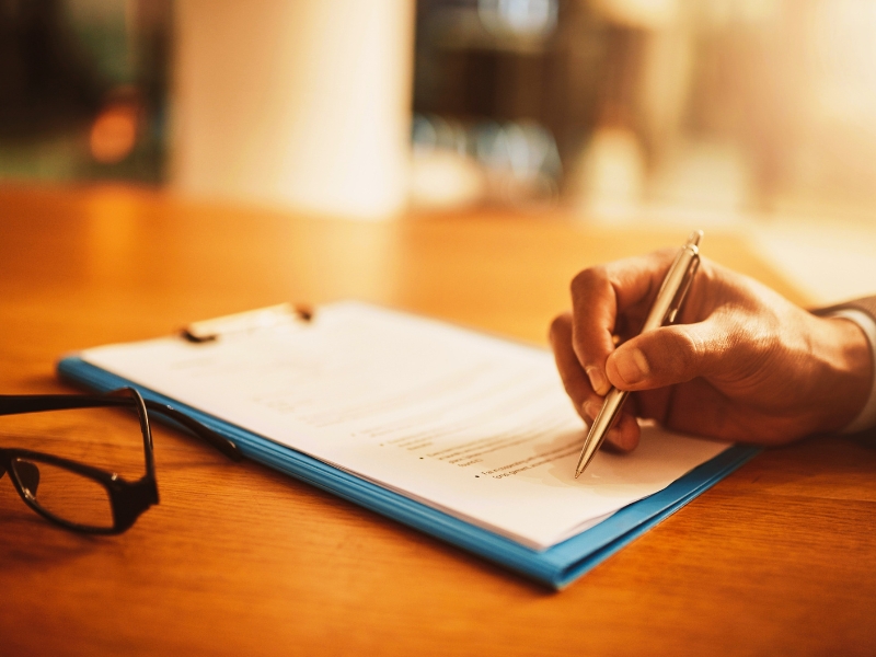 Lawyer hand showing paperwork for signing, agreement contract and settlement offer in law firm office