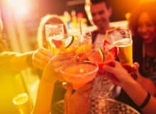 Shot of a group of people toasting with their drinks at a nightclub