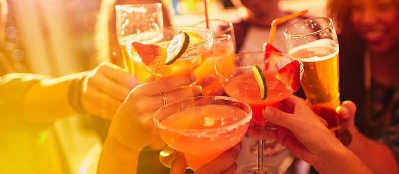 Shot of a group of people toasting with their drinks at a nightclub