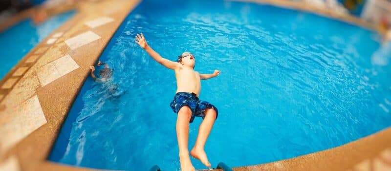 Fun, relaxed parents swimming with children