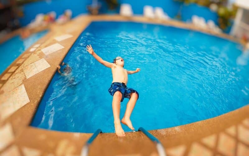 Fun, relaxed parents swimming with children