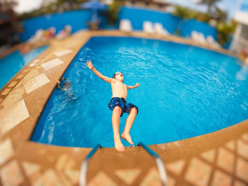 Fun, relaxed parents swimming with children