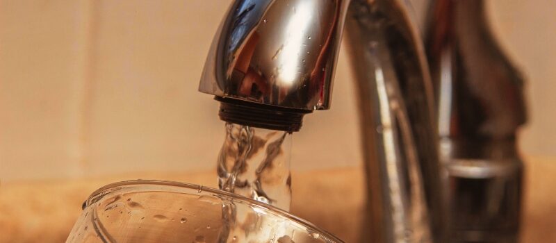 Glass at water tap and filling water with VOCs