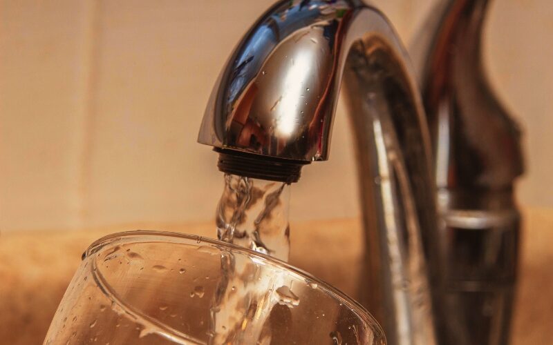 Glass at water tap and filling water with VOCs