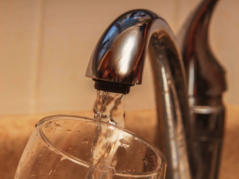 Glass at water tap and filling water with VOCs