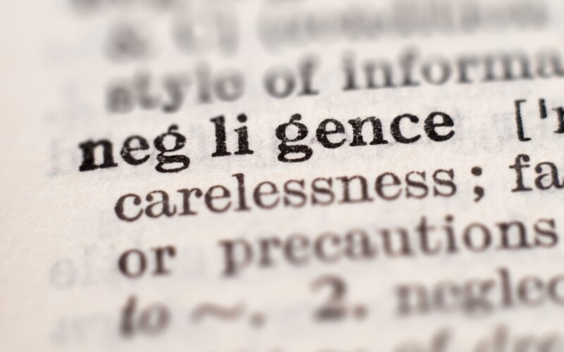 Dictionary definition of word negligence, selective focus. Concept of what are the four types of negligence