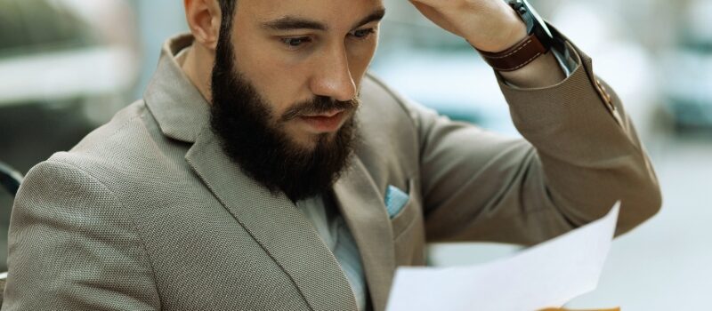 A shocked man reads a court letter