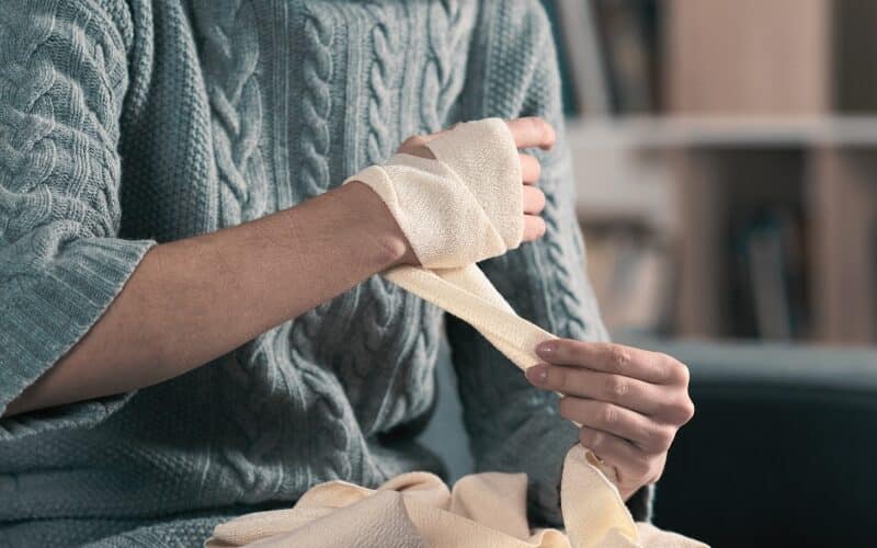 Injured woman hands removing bandage from arm. Concept of What the New Florida Comparative Fault Reform Means for Your Personal Injury Case 1
