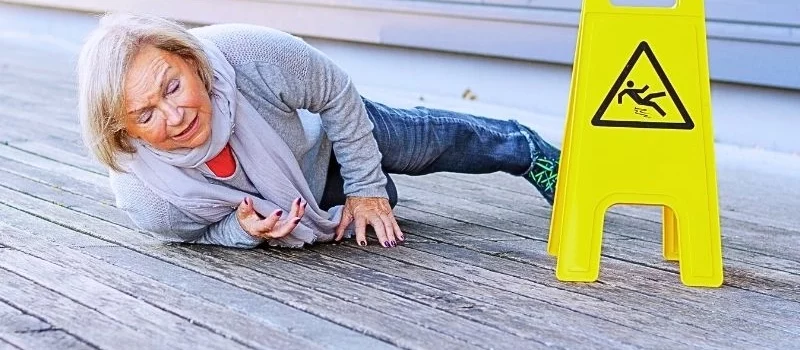 Senior lady slipping and falling on a wet surface. common slip and fall injuries