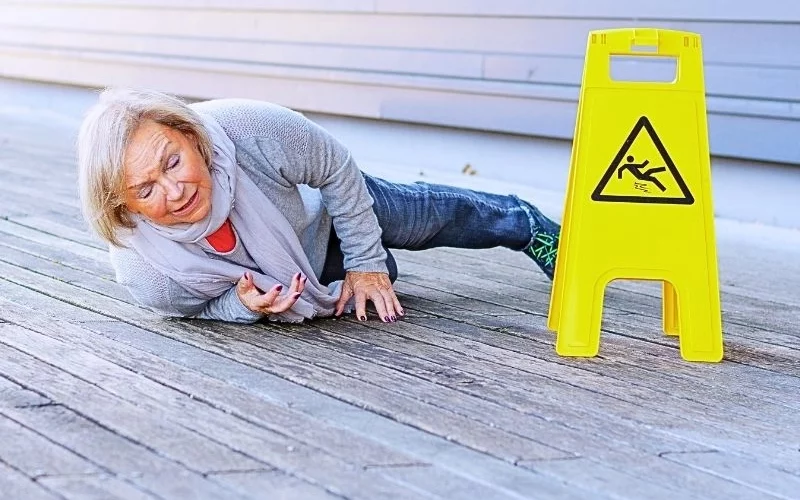 Senior lady slipping and falling on a wet surface. common slip and fall injuries
