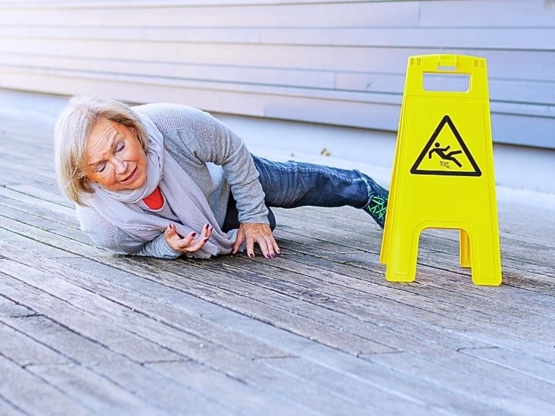 Senior lady slipping and falling on a wet surface. common slip and fall injuries