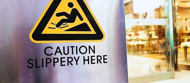 Caution sign at store. Slip and fall liability