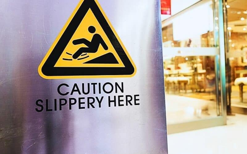 Caution sign at store. Slip and fall liability