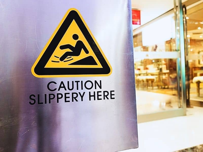 Caution sign at store. Slip and fall liability