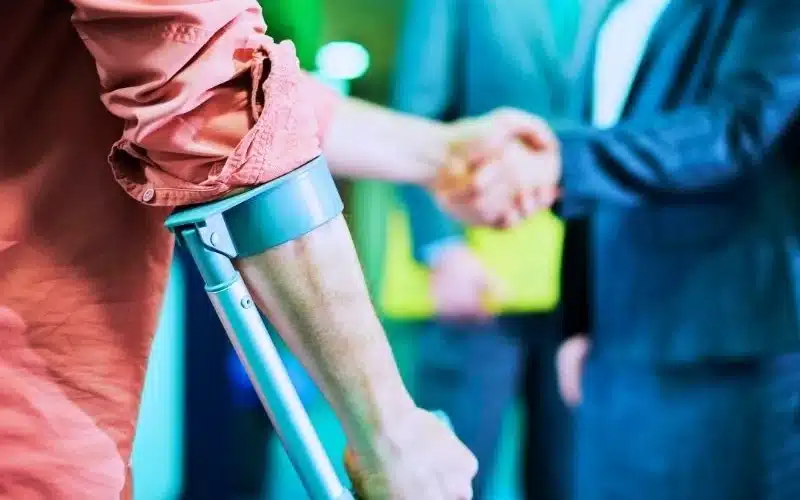 Injured man shaking hands with his lawyer.