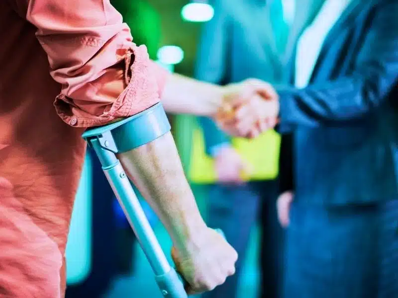 Injured man shaking hands with his lawyer.