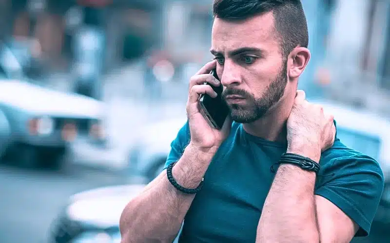 Frustrated man using his mobile phone.