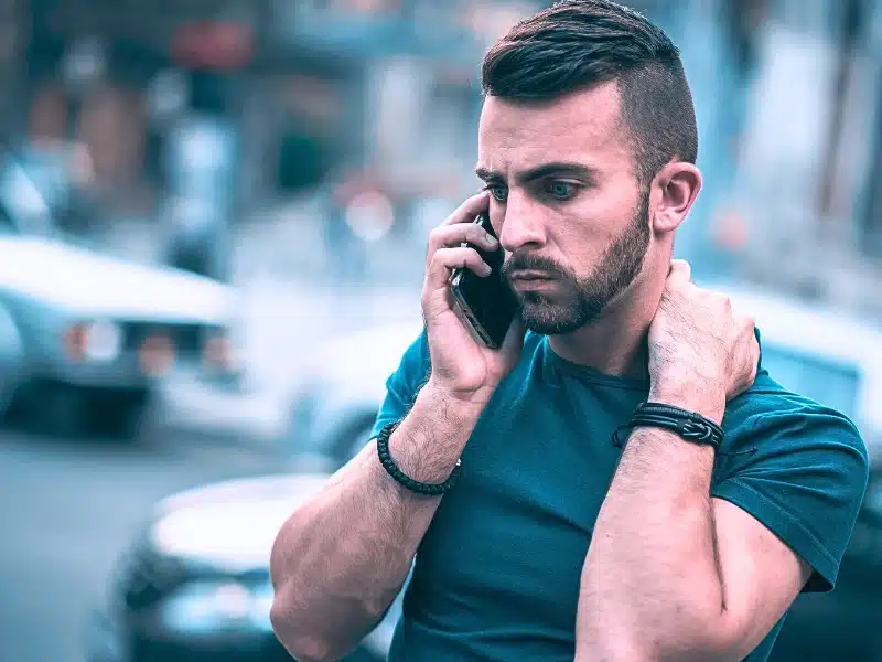 Frustrated man using his mobile phone.