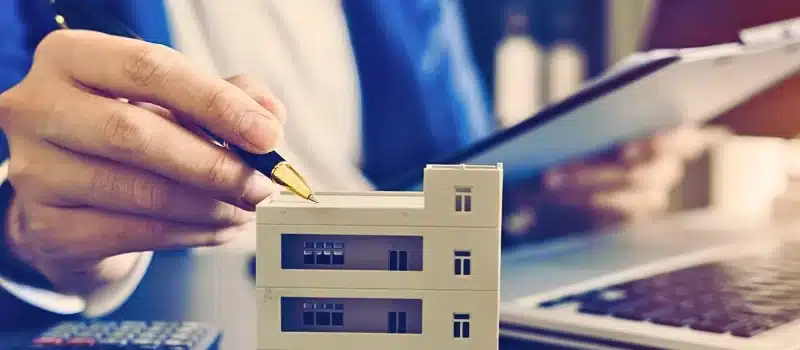 A woman calculating the value of a property.