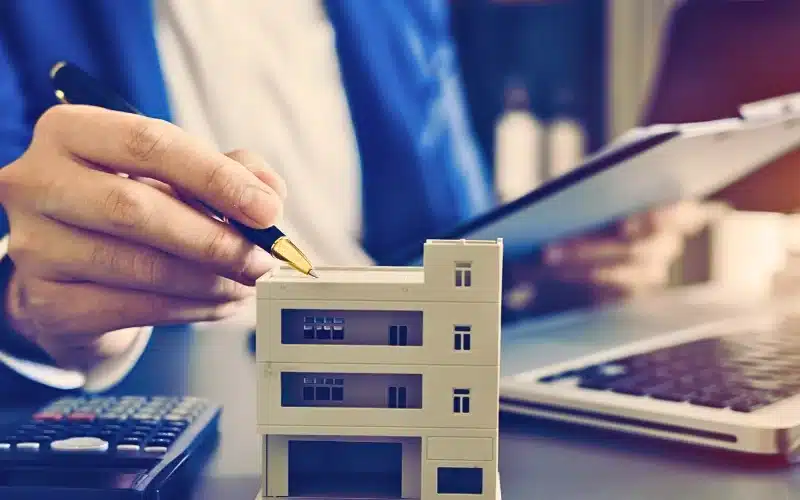 A woman calculating the value of a property.