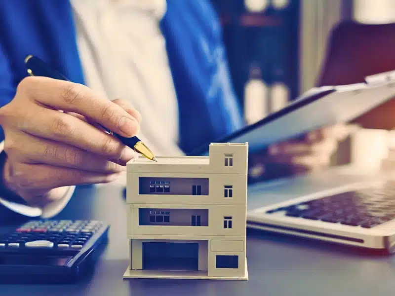 A woman calculating the value of a property.