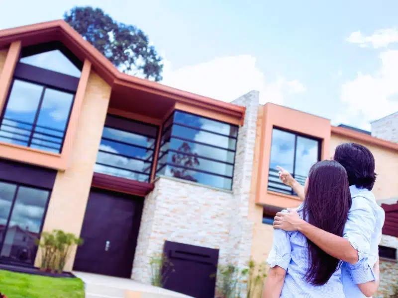 Couple with their new home.