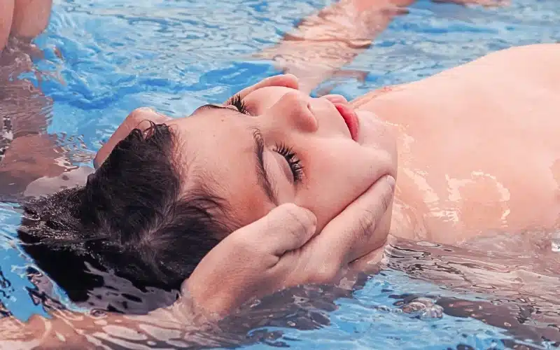 Little boy learning how to swim.