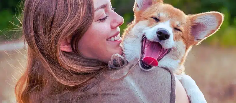 Woman holding her pet dog.