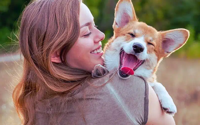 Woman holding her pet dog.