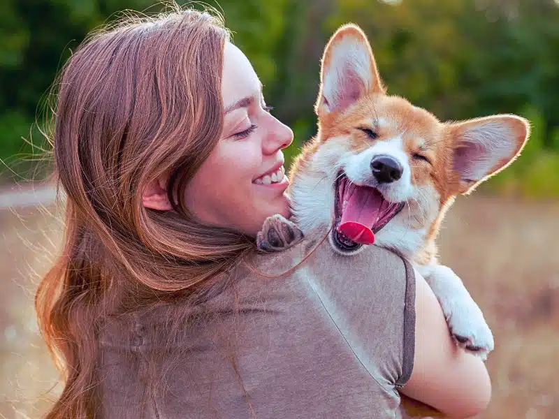 Woman holding her pet dog.