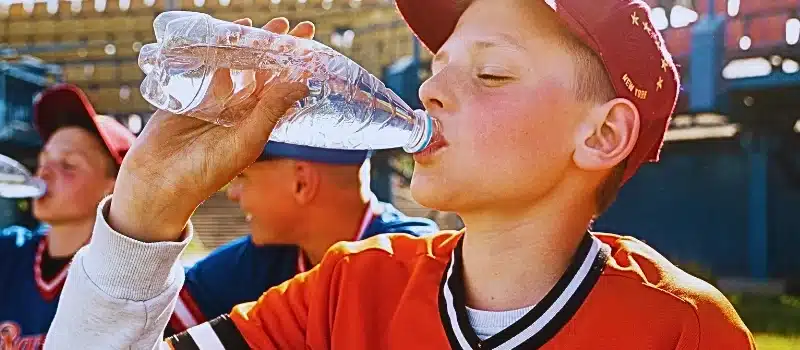 Side view kid drinking water.