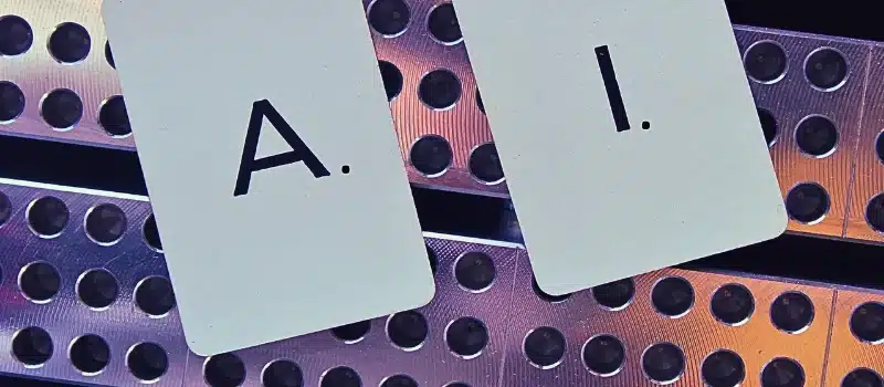 Close-up of letters of A I on cards against railing.