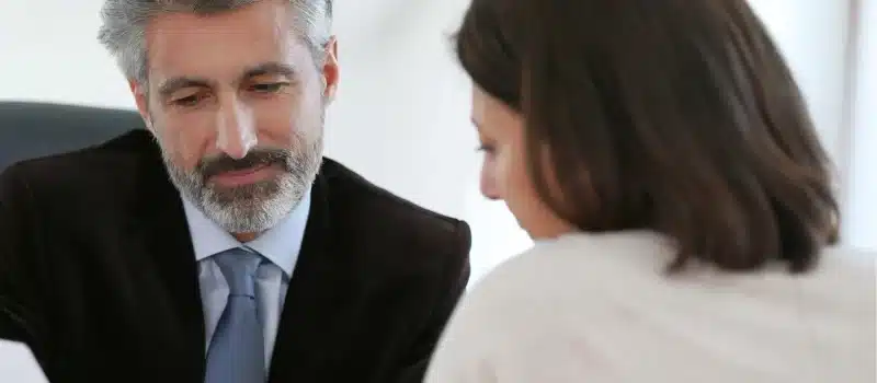 Male lawyer talking to a woman patient.
