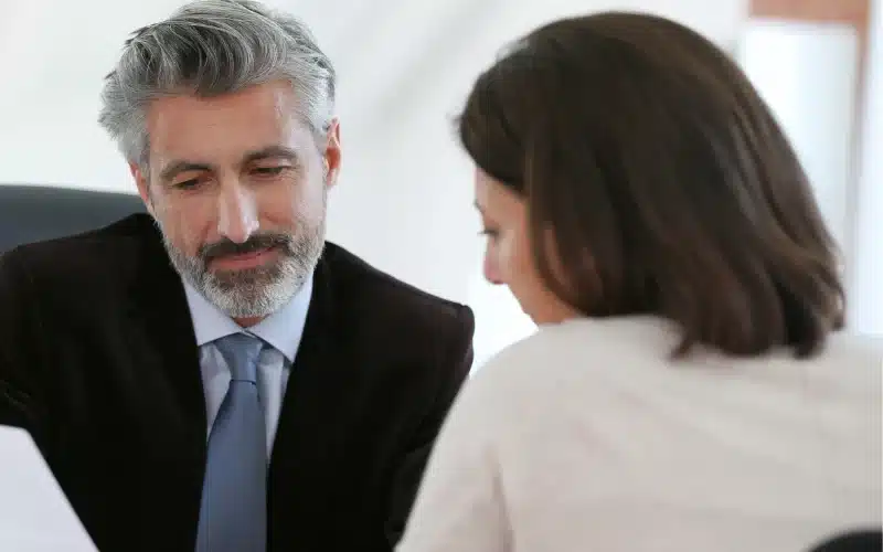 Male lawyer talking to a woman patient.