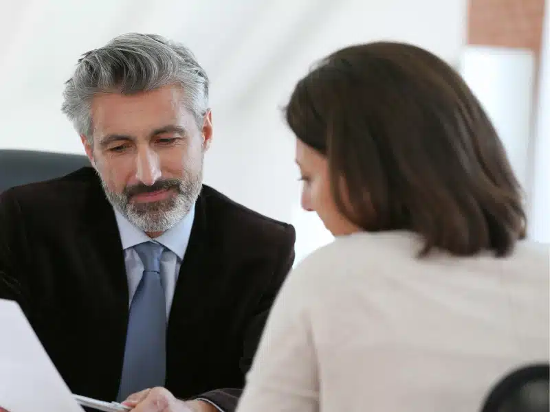 Male lawyer talking to a woman patient.