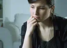 Frustrated woman wearing black dress.